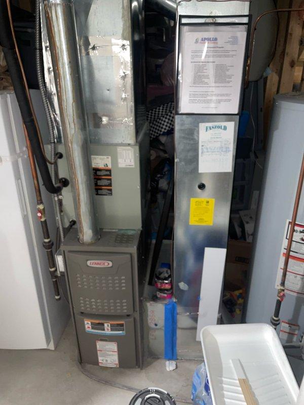 Responded to service call for reduced airflow from AC system. Upon arrival, verified thermostat was calling for cooling with setpoint at 73°F. Inspected Apollo furnace/air handler unit in basement and assessed blower operation, ductwork connections, and filter accessibility. System was running but experiencing diminished air delivery as reported. Documented equipment condition and thermostat settings with photos for service records.