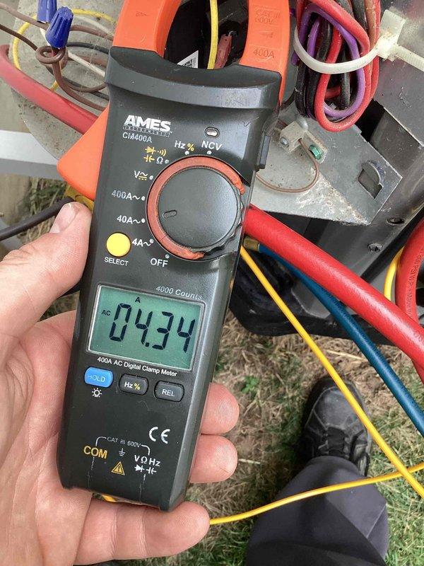 Responded to no cooling complaint on 3-year-old residential air conditioning system. Performed diagnostic testing using digital clamp meter to measure amperage draws on outdoor condensing unit. Recorded compressor amperage at 4.34A and condenser fan motor amperage at 0.58A, both within normal operating parameters. Verified proper electrical connections and wiring integrity at outdoor unit. System operational upon completion of diagnostics and repairs.