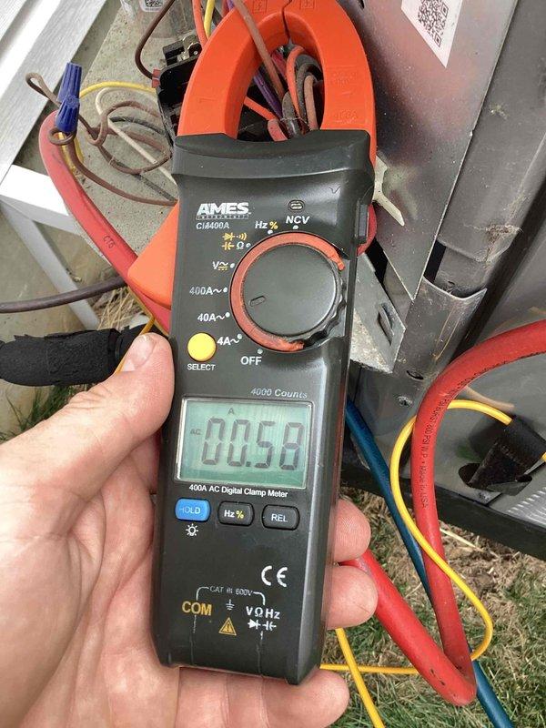 Responded to no cooling complaint on 3-year-old residential air conditioning system. Performed diagnostic testing using digital clamp meter to measure amperage draws on outdoor condensing unit. Recorded compressor amperage at 4.34A and condenser fan motor amperage at 0.58A, both within normal operating parameters. Verified proper electrical connections and wiring integrity at outdoor unit. System operational upon completion of diagnostics and repairs.