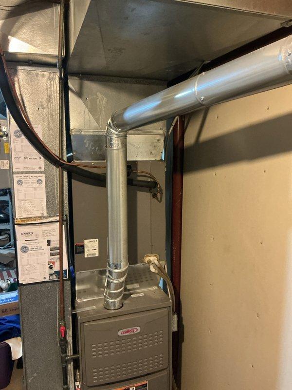 Responded to service call for thermostat issue on Lennox furnace system located in basement utility area. Upon arrival, inspected HVAC unit and verified system operation, checked thermostat communication and control signals, and confirmed proper furnace cycling. Documented equipment condition with photos showing well-maintained installation with intact ductwork, proper venting, and secure connections throughout the system.