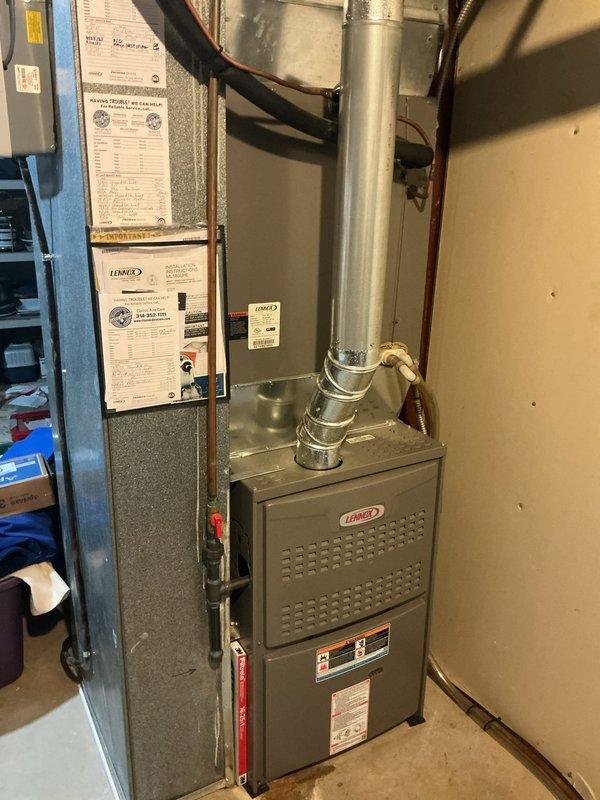 Responded to service call for thermostat issue on Lennox furnace system located in basement utility area. Upon arrival, inspected HVAC unit and verified system operation, checked thermostat communication and control signals, and confirmed proper furnace cycling. Documented equipment condition with photos showing well-maintained installation with intact ductwork, proper venting, and secure connections throughout the system.