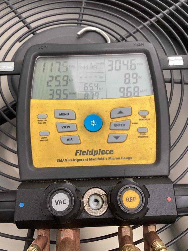 Responded to service call for 10-year-old outdoor AC unit experiencing loud revving noises. Upon arrival, performed electrical diagnostics using digital clamp meter to measure amperage draw on compressor circuit, recording 0.58 amps. Connected refrigerant manifold gauge set to service ports and measured system pressures and temperatures across both high and low sides to assess refrigerant charge and system performance. Diagnostic readings indicated system operating parameters, with temperatures ranging from 117°F to 395°F and pressures measuring 304.6 PSI on high side and 85-96.8 PSI on low side, confirming proper refrigerant levels and compressor operation within normal range.