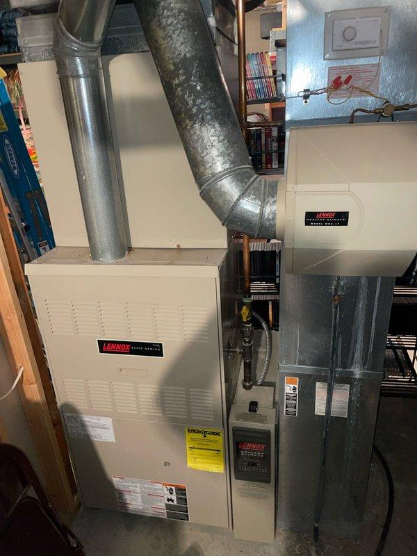 Responded to heating complaint affecting multiple rooms on lower level of residence. Upon inspection of 16-year-old Lennox furnace system, discovered significant crack in condensate drain hose causing system safety shutdown. The damaged black rubber drain line exhibited extensive splitting and material deterioration due to age and brittleness. Replaced failed condensate drain hose with new component, secured all connections, and verified proper drainage. Tested system operation across all zones to confirm restored heating functionality throughout affected areas. System now operating within normal parameters with all rooms receiving adequate heat distribution.