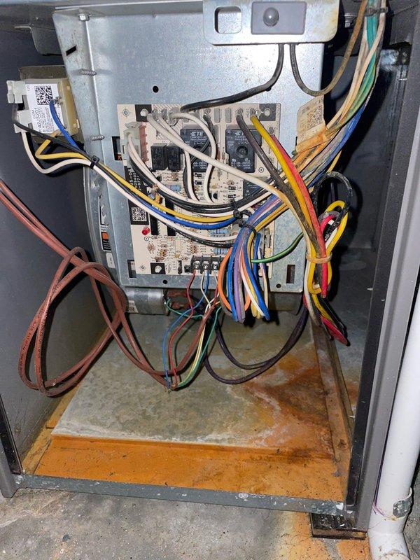 Replaced defective high limit switch on furnace system. Unit displayed signs of significant corrosion and moisture damage throughout the cabinet interior, with extensive rust visible on drip pans and base surfaces. Accessed control board compartment, removed failed high limit switch, and installed new replacement part. Verified all electrical connections were secure and tested system operation to ensure proper cycling and safety controls functioning correctly.