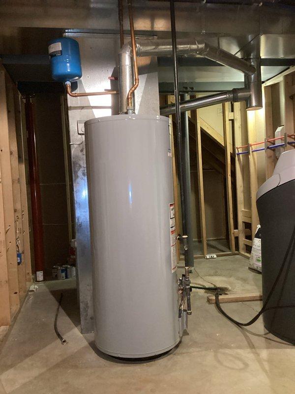 Completed warranty replacement installation of 50-gallon tall gas water heater in basement utility room. Removed existing failed unit, documented warranty information from old equipment per manufacturer requirements, and installed new heater with proper copper piping connections, gas line hookup, pressure relief valve, and venting. All plumbing connections were secured with appropriate fittings and valves, expansion tank verified in proper working position, and unit tested for proper operation and safety compliance.