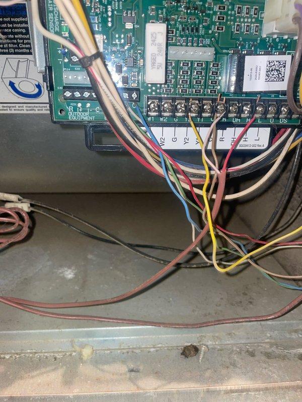 Responded to service call for malfunctioning thermostat on 12-year-old HVAC system. Accessed thermostat equipment settings menu and inspected control board wiring connections at furnace, verifying proper terminal connections for heating and cooling circuits. Documented system configuration and control board condition for diagnostic purposes.