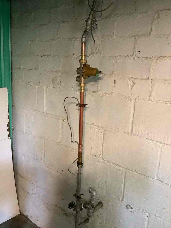 Installed 40-gallon short gas water heater with copper supply piping and proper venting connections. Installed 3/4-inch pressure reducing valve on main water supply line and mounted blue expansion tank to system. Completed installation under City of University City permit and verified all connections for proper operation.