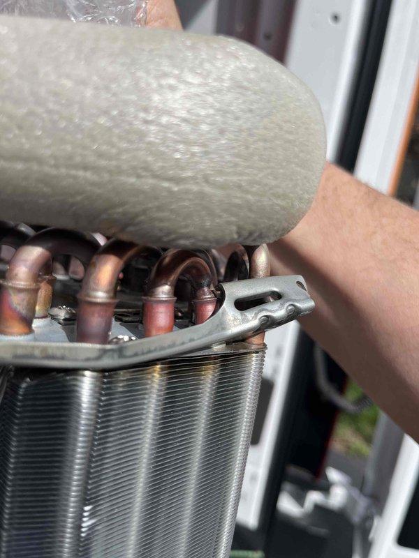 Replaced defective mini-split evaporator coil under warranty for unit S/N 6009299T. Removed failed coil assembly, installed new evaporator coil with copper refrigerant lines and heat exchanger components, and secured insulated piping with proper fasteners. System restored to full heating and cooling operation, and defective part retained per warranty requirements.