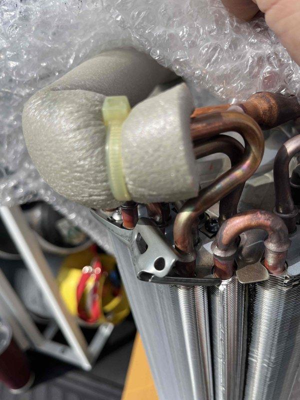 Replaced defective mini-split evaporator coil under warranty for unit S/N 6009299T. Removed failed coil assembly, installed new evaporator coil with copper refrigerant lines and heat exchanger components, and secured insulated piping with proper fasteners. System restored to full heating and cooling operation, and defective part retained per warranty requirements.