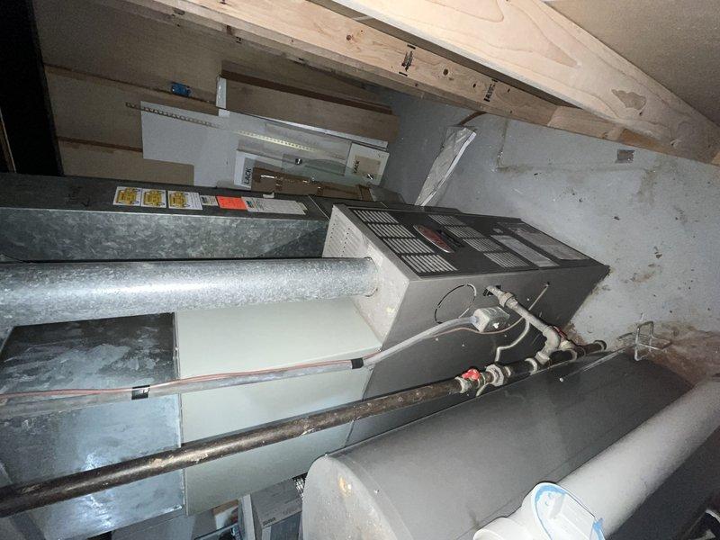 Responded to no cooling call on 9-year-old air conditioning system where indoor blower was operating but outdoor unit failed to run. Upon arrival, performed diagnostic testing and measured voltage at outdoor unit using digital multimeter, which revealed electrical issue preventing compressor operation. Inspected attic-mounted air handler and associated refrigerant lines, ductwork, and electrical connections. Identified failed capacitor as root cause of outdoor unit failure. Replaced defective dual run capacitor with manufacturer-specified component, restoring power to compressor and condenser fan motor. Verified proper voltage readings, confirmed outdoor unit operation, and tested system performance. System now cooling properly with both indoor and outdoor units functioning as designed.