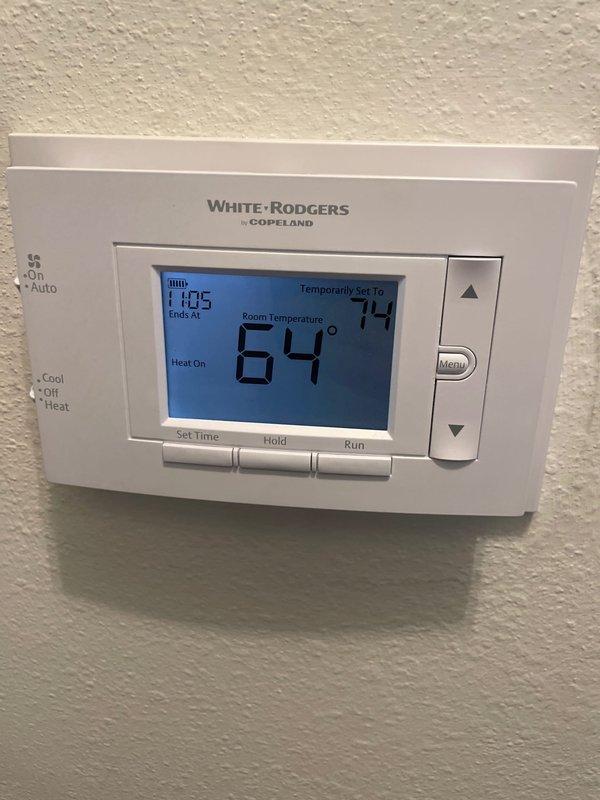Responded to no heat call on unit less than 10 years old. Upon arrival, verified thermostat was calling for heat with system set to 74°F while room temperature read 64°F. Inspected White-Rodgers programmable thermostat showing "Heat On" status and confirmed proper settings. Examined unit's diagnostic error code chart and conducted system evaluation. Determined unit operational and restored heating function. System tested and verified proper operation before departure.