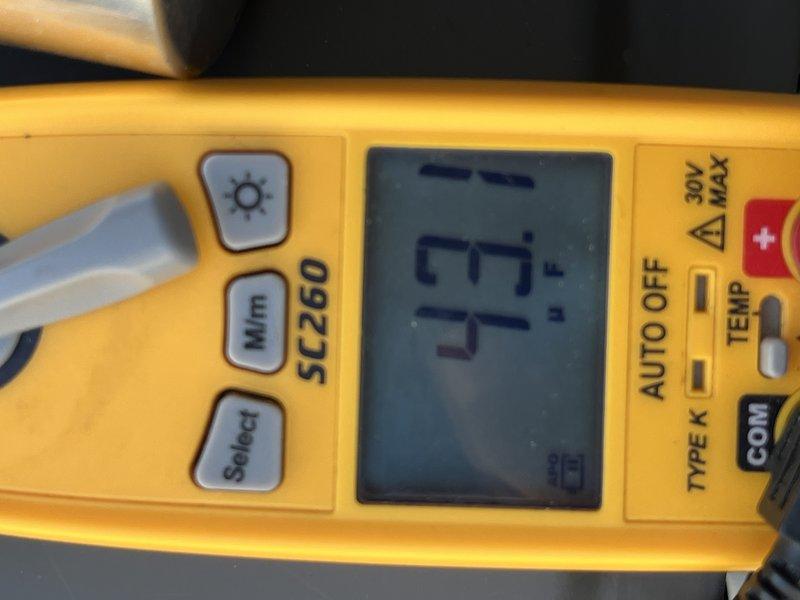 Completed seasonal cooling tune-up on 12-year-old residential air conditioning unit located at side of house. Performed comprehensive system diagnostics using digital multimeter to verify electrical readings and temperature measurements, confirming all components operating within normal parameters.