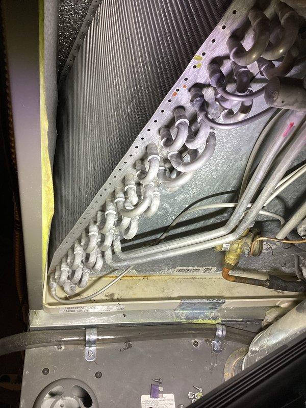 Responded to customer complaint of mildew odor from AC system upon seasonal startup. Performed inspection of 2-year-old Lennox unit and identified dust and debris accumulation on evaporator coil assembly. Cleaned evaporator coil fins, verified refrigerant line connections, and inspected electrical components and control board for proper operation. System tested successfully with no odor detected after cleaning, all components functioning within normal parameters.