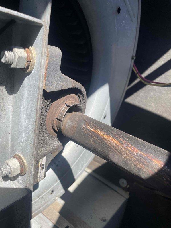 Responded to callback for excessive vibration in rooftop HVAC unit serving dining room area, which was causing structural shaking severe enough to break glassware following recent maintenance. Upon inspection, discovered deteriorated and corroded mounting shaft on unit support assembly. The cylindrical mounting rod exhibited significant rust and oxidation, compromising the structural integrity of the isolation mount. Replaced failed mounting bracket assembly and corroded shaft with new hardware to restore proper vibration isolation. Verified all mounting bolts were properly torqued and unit was securely fastened to roof curb. Cycled unit through full operation and confirmed vibration levels returned to normal specifications with no excessive movement transmitted to building structure.