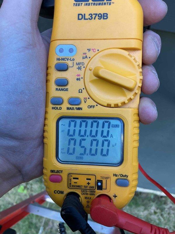 Completed preventive maintenance tune-up on a 10-year-old residential HVAC system with two cylindrical condensing units mounted on raised brackets at ground level. Performed comprehensive system inspection, tested electrical components and voltage readings using digital multimeter, verified proper operation of both units, and confirmed all measurements were within manufacturer specifications.