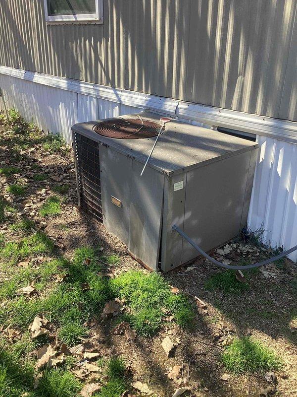 Completed no-cooling diagnostic service call on residential property with two HVAC units. Inspected 10-year-old outdoor condensing unit located at side of home near utility closet. Unit showed signs of weathering and debris accumulation but was operational at time of inspection. Documented equipment condition and installation environment, noting unit placement directly on ground without proper concrete pad. Verified system functionality and provided customer with maintenance recommendations for both units.