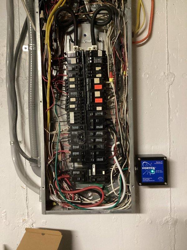 Completed installation of two whole-home surge protection devices on residential electrical panel. Installed surge protectors with proper wiring connections to main panel, ensuring adequate protection for all downstream circuits. Mounted monitoring display unit on wall adjacent to panel for real-time surge protection status visibility and system diagnostics.