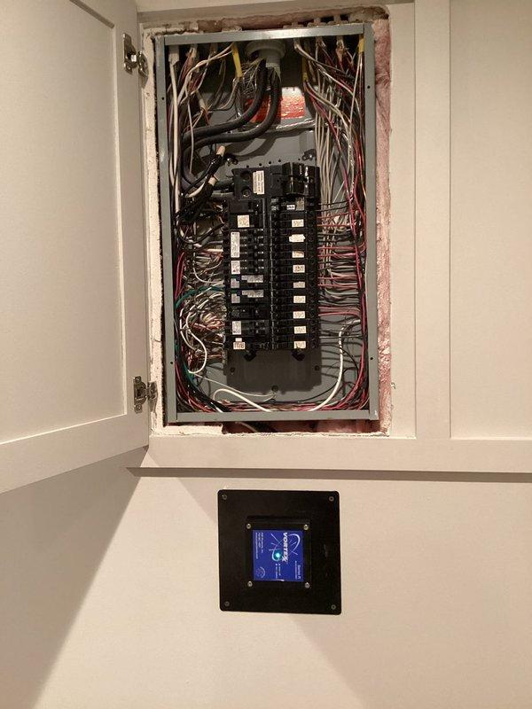 Completed installation of two whole-home surge protection devices on residential electrical panel. Installed surge protectors with proper wiring connections to main panel, ensuring adequate protection for all downstream circuits. Mounted monitoring display unit on wall adjacent to panel for real-time surge protection status visibility and system diagnostics.