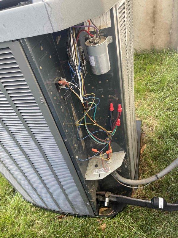 Completed comprehensive cooling maintenance on 15-year-old Trane air conditioning system. Performed full system inspection including electrical connections, capacitor testing, refrigerant line examination, and component evaluation. Accessed outdoor unit service compartment, inspected compressor, verified all refrigerant connections and insulation integrity on copper lines. Checked capacitor function and electrical wiring connections throughout control panel. Cleaned debris accumulation from interior compartment and exterior surfaces. All components tested and operating within normal parameters; system confirmed cooling properly with no immediate service needs identified.