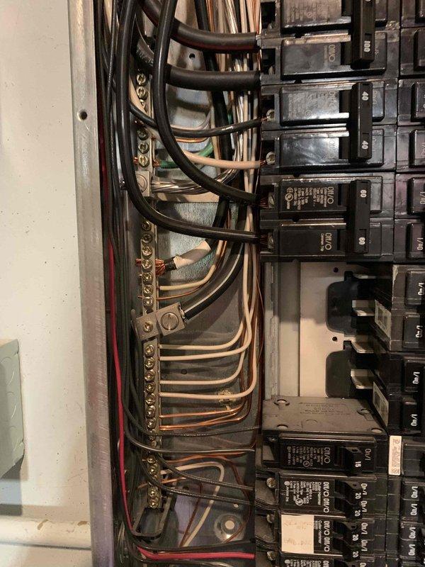 Completed comprehensive electrical safety inspection of residential property. Examined interior light switch installation, noting standard toggle switch with visible wear and dust accumulation around mounting box and exposed wiring connections. Inspected main electrical panel with cover removed, documenting circuit breaker arrangement, wire routing, and terminal connections on bus bars. All components photographed for record-keeping purposes. No immediate safety hazards identified during visual inspection.