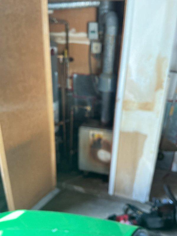 Responded to service call for older boiler unit located in garage experiencing leaking and overheating issues. Upon arrival, conducted thorough inspection of boiler system and surrounding mechanical equipment in utility space. Assessed visible piping, connections, and mechanical components to identify source of water leak and determine cause of overheating condition. Documented equipment condition and workspace setup for service records.