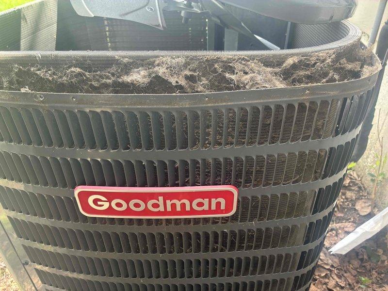 Completed cooling system tune-up on Goodman air conditioning unit located in backyard. Unit showed significant debris accumulation on condenser coils and fins, which was cleaned to restore proper airflow and heat transfer efficiency. Inspected and replaced dirty air filter to improve indoor air quality and system performance.