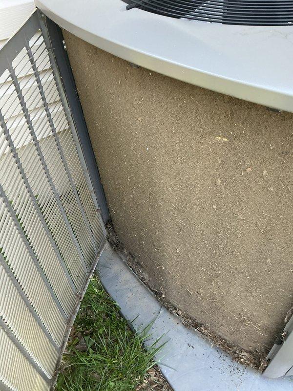 Completed preventive maintenance tune-up on a 2-year-old residential HVAC system. Performed comprehensive inspection of outdoor condenser unit, noting debris accumulation around base and concrete pad requiring cleaning. Inspected indoor air handler and discovered significant dust buildup on evaporator coil and filter assembly, indicating overdue filter replacement. Cleaned condenser coil fins, cleared debris from unit perimeter and concrete pad, replaced air filter, and verified system operational status. All components functioning properly following service completion.