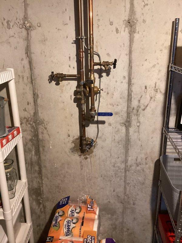 Completed installation of 50-gallon tall gas water heater in basement utility area. Unit was positioned adjacent to existing furnace with proper clearances maintained for service access and ventilation requirements. Connected copper supply lines and gas piping to new water heater, installed required shut-off valves, and completed all necessary fittings per code. Applied required identification sticker to unit for permit compliance under permit #26PLU-06456. Verified proper venting configuration, tested all connections for leaks, and confirmed unit operational status upon completion.