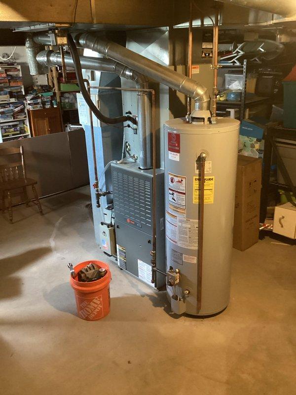 Completed installation of 50-gallon tall gas water heater in basement utility area. Unit was positioned adjacent to existing furnace with proper clearances maintained for service access and ventilation requirements. Connected copper supply lines and gas piping to new water heater, installed required shut-off valves, and completed all necessary fittings per code. Applied required identification sticker to unit for permit compliance under permit #26PLU-06456. Verified proper venting configuration, tested all connections for leaks, and confirmed unit operational status upon completion.