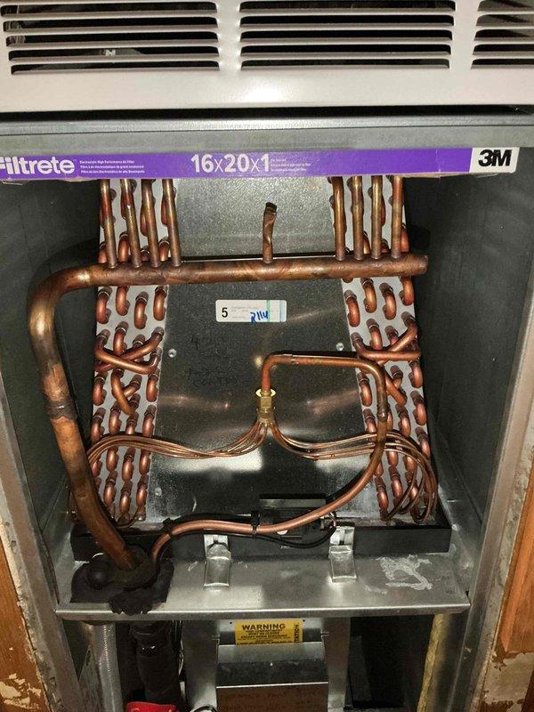 Responded to service call for residential A/C unit not maintaining setpoint temperature on system less than one year old. Upon arrival, performed comprehensive system inspection including visual examination of indoor air handler and evaporator coil assembly. Verified proper installation of 16x20x1 air filter and confirmed adequate airflow through evaporator coil. Inspected refrigerant line set connections, copper piping configuration, and coil condition for any signs of restriction, leakage, or mechanical issues. Checked electrical connections, wire terminations, and safety controls. Documented system components including blower assembly, ductwork connections, and overall installation quality. System evaluated for proper refrigerant charge, airflow balance, and operational performance to identify root cause of inadequate cooling capacity.