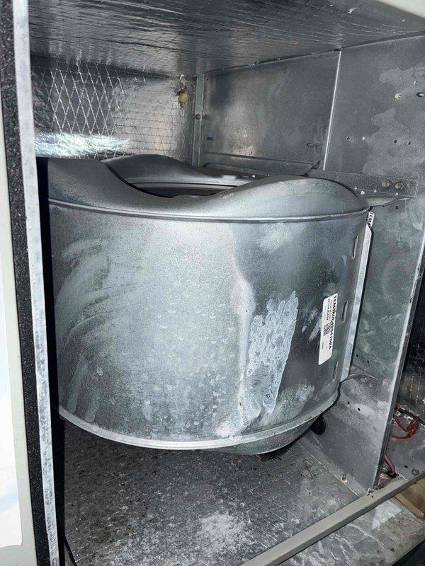 Performed seasonal cooling tune-up on 3-year-old residential HVAC system located in attic. Conducted comprehensive inspection of blower assembly, which showed normal condensation accumulation on drum housing. Verified electrical performance using digital multimeter, confirming proper amperage draw at 100.7A. Inspected air filter, ductwork connections, and cabinet interior. System operating within normal parameters with no deficiencies noted.