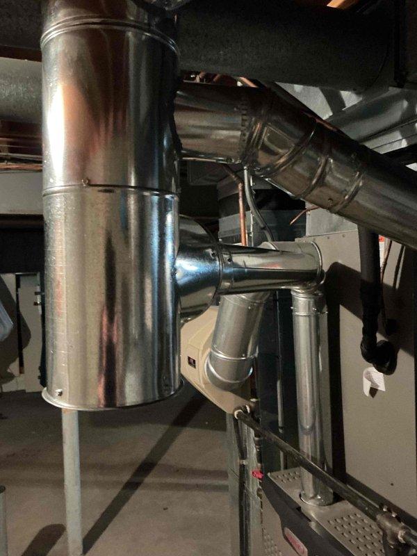 Replaced defective swivel tee and associated ductwork fittings in HVAC system. Installed new 7x4x4 swivel tee, 7" tee, 7-3" reducer, sections of 4" and 3" pipe, along with multiple 90-degree elbows to restore proper airflow and eliminate moisture condensation issues observed at connection points. Removed and disposed of failed components, ensuring all new ductwork connections were properly sealed and secured.