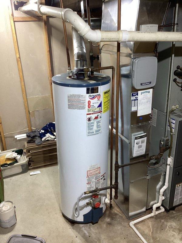 Replaced antiquated 50-gallon gas water heater with new 50-gallon tall gas unit in basement location. Verified incoming water pressure to residence and installed 3/4" pressure reducing valve as part of installation to protect plumbing system. Connected all supply and discharge lines, installed proper venting through existing infrastructure, and ensured all safety devices and temperature/pressure relief valve were properly installed and operational. Unit tested successfully with no leaks detected at any connections.