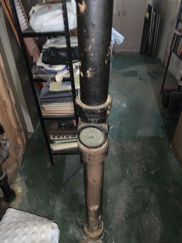 Responded to main drain cleanout service requiring cable access from roof with two-technician crew as specified. Upon arrival, accessed main drainage system through roof entry point and assessed condition of vertical waste pipe showing significant corrosion and deterioration. Performed cable cleanout procedure on main line to clear obstruction and restore proper drainage flow. Documented existing infrastructure conditions including heavily corroded vertical drain pipe with rusted fittings and deteriorated floor drains in basement utility area. Work completed as scheduled return visit coordinating with previous service request. Additional repairs will be required to address corroded piping and compromised drainage system components identified during service.