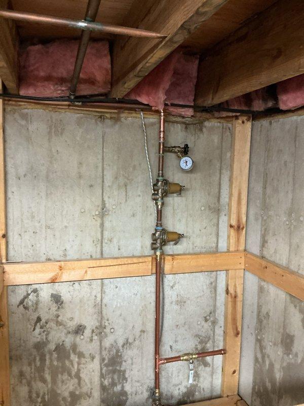 Installed 50-gallon tall gas water heater in basement utility area. Completed all necessary copper piping connections, installed pressure relief valve assembly with discharge piping, and connected gas supply line with shutoff valve. Applied required plumbing identification sticker and ensured all work complied with permit #26PLU-06711. Unit tested and verified operational with all safety controls functioning properly.