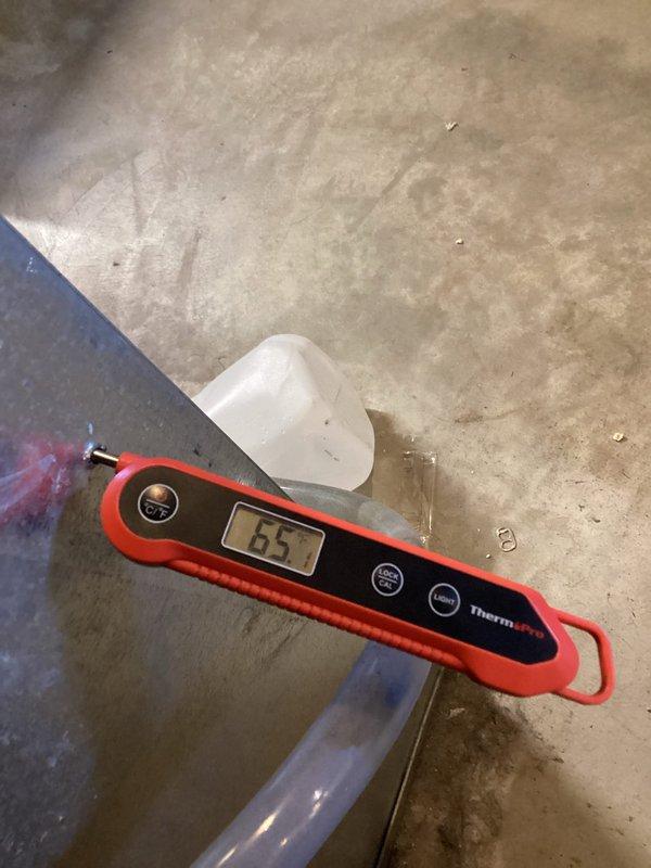 Responded to thermostat error code 413 indicating high pressure switch fault on condenser unit. Upon arrival, connected manifold gauges and confirmed system pressures were significantly elevated above normal operating parameters. System currently overcharged due to previous service incident in November where refrigerant leaked during gauge connection and 3 pounds of R-410A were added to a system with 6 pound 8 ounce factory charge specification. Utilized recovery machine to properly evacuate refrigerant from system into recovery tank. Measured and documented pressures showing high-side reading of 410.7 PSIG with ambient temperature of 65°F, confirming overcharge condition. After complete refrigerant recovery, recharged system to manufacturer specifications of 6 pounds 8 ounces of R-410A refrigerant. Verified proper superheat and subcooling values, cleared high pressure switch error, and confirmed system returned to normal operation with appropriate operating pressures and temperatures.