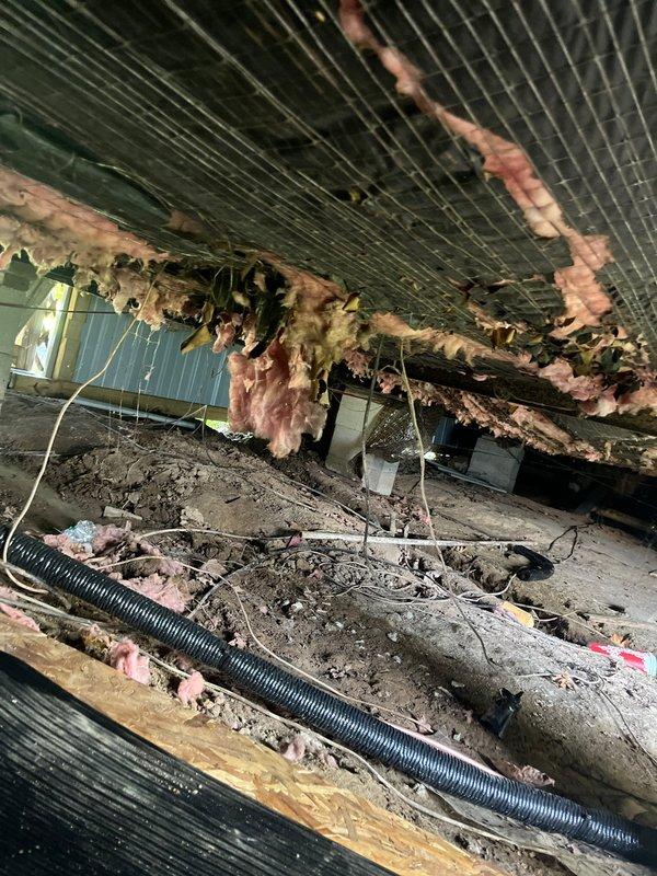 Replaced refrigerant line set for HVAC system requiring access to crawl space beneath home. Deployed protective tarps due to wet conditions under structure before performing work. Documented existing conditions showing deteriorated insulation, accumulated debris, and contaminated air handler components with significant biological growth and material buildup on coils and interior surfaces. Line set replacement completed as warranty work related to original installation.