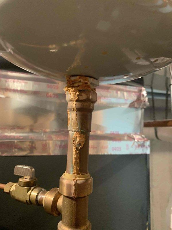 Successfully installed a 50-gallon tall natural gas water heater in basement location, replacing a 12-year-old unit that showed significant corrosion and deterioration on pipe fittings and connections. Removed existing water heater and installed new unit with proper venting, gas line connections, and water supply lines per manufacturer specifications and local plumbing code requirements. Applied required plumbing identification sticker and obtained permit approval for installation to ensure compliance with municipal regulations.