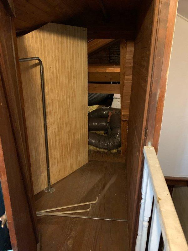 Responded to maintenance code displayed on thermostat for HVAC system less than 10 years old located on second floor hallway. Accessed attic space through hallway entry point and performed comprehensive inspection of air handling unit, ductwork, and associated electrical connections. Found disorganized wiring and displaced insulation in attic area near equipment. Inspected flexible ductwork routing, verified proper connections, and examined electrical conduit and junction boxes for secure mounting. Cleared thermostat error code, tested system operation, and confirmed unit returned to normal functionality. Documented attic conditions with photos showing equipment access area, structural framing, insulation status, and electrical component locations for future reference.