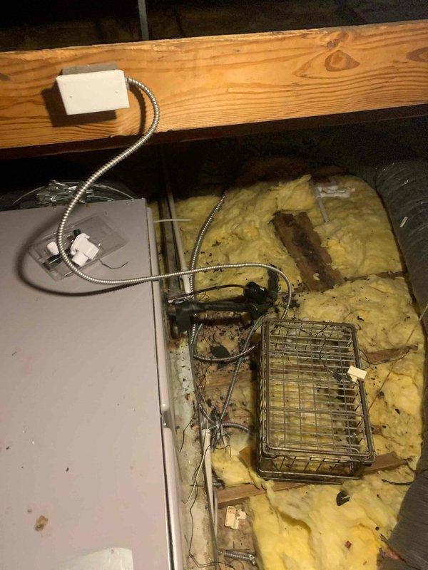 Responded to maintenance code displayed on thermostat for HVAC system less than 10 years old located on second floor hallway. Accessed attic space through hallway entry point and performed comprehensive inspection of air handling unit, ductwork, and associated electrical connections. Found disorganized wiring and displaced insulation in attic area near equipment. Inspected flexible ductwork routing, verified proper connections, and examined electrical conduit and junction boxes for secure mounting. Cleared thermostat error code, tested system operation, and confirmed unit returned to normal functionality. Documented attic conditions with photos showing equipment access area, structural framing, insulation status, and electrical component locations for future reference.