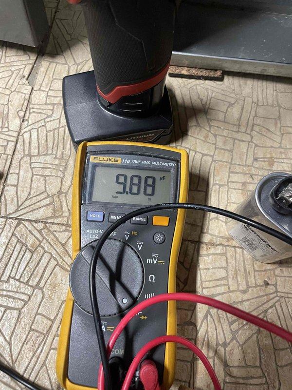 Completed comprehensive cooling tune-up on 11-year-old outdoor condensing unit. Upon inspection, found condenser coils heavily soiled with dirt, dust, and debris accumulation causing significant airflow restriction. Performed thorough coil cleaning to restore proper heat transfer efficiency, removed access panel to access internal components, and took temperature differential readings using digital multimeter to verify system performance. Unit returned to optimal operating condition with improved airflow through coil assembly.