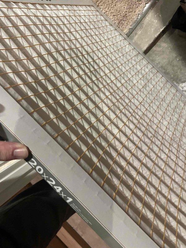 Completed comprehensive cooling system tune-up on residential AC unit located at side of home. Performed standard maintenance protocol including inspection of evaporator coil assembly, which showed moderate dust accumulation between aluminum fins, and return air grille, which exhibited significant dust and debris buildup on internal surfaces and slat edges. Documented system condition with photographs for service records.