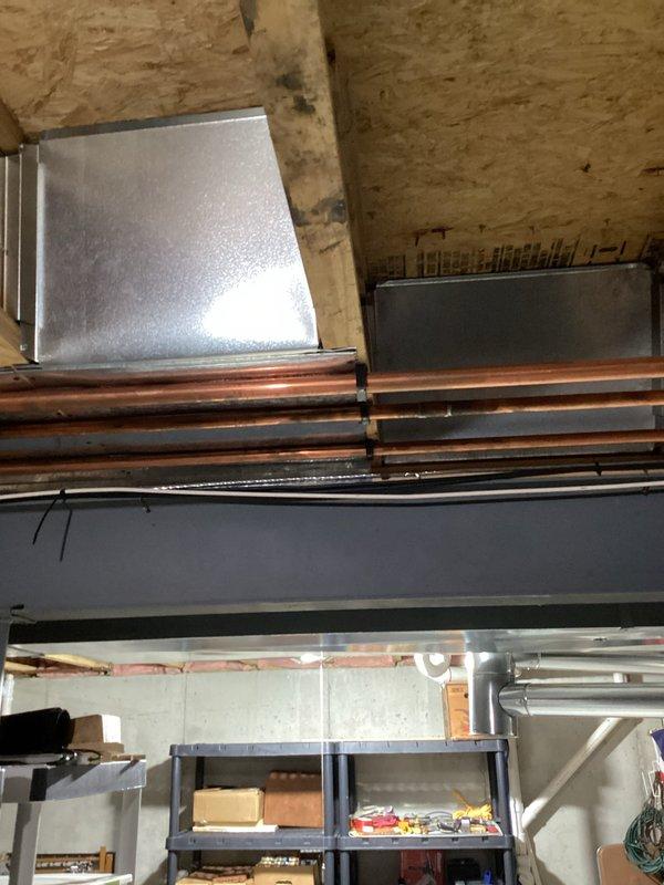 Conducted on-site assessment for whole-house generator installation in residential property. Evaluated existing electrical infrastructure, including main service panel location, available space for generator placement, and utility connections. Documented basement mechanical area showing copper plumbing lines, HVAC ductwork, and structural considerations that will impact installation requirements and transfer switch placement.