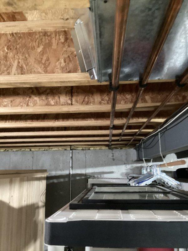 Conducted on-site assessment for whole-house generator installation in residential property. Evaluated existing electrical infrastructure, including main service panel location, available space for generator placement, and utility connections. Documented basement mechanical area showing copper plumbing lines, HVAC ductwork, and structural considerations that will impact installation requirements and transfer switch placement.