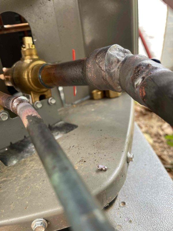 Responded to repair leak at suction service valve on HVAC unit. Upon arrival, located heavily corroded suction line and service valve connection showing significant oxidation and surface deterioration. Repaired leak at suction service valve using parts from van stock. Utilized electronic scale to measure and add refrigerant charge to system. Verified system operation and confirmed unit is heating and cooling properly. System restored to normal operation with no active leaks detected.