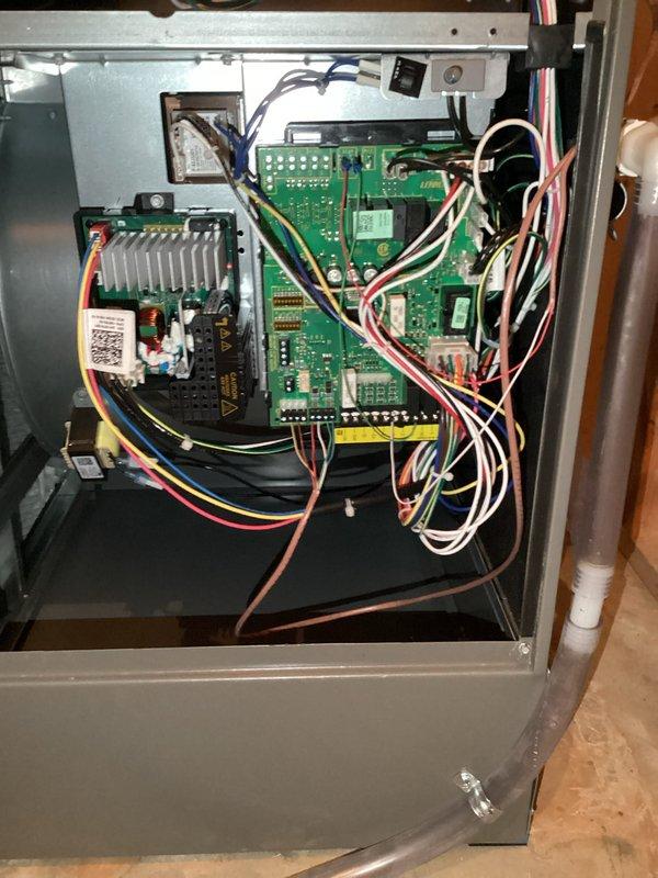 # HVAC Tune-Up Completed

Performed comprehensive preventive maintenance tune-up on a 1-year-old residential air conditioning system for Home Depot service order F58577107. Inspected indoor furnace control board assembly, verifying proper operation of dual PCB control system, all wiring connections, and safety circuits. Examined outdoor condenser unit coils, noting moderate dirt and debris accumulation on aluminum fins; cleaned coil surfaces to restore optimal heat transfer efficiency and airflow. System operational and ready for continued service.