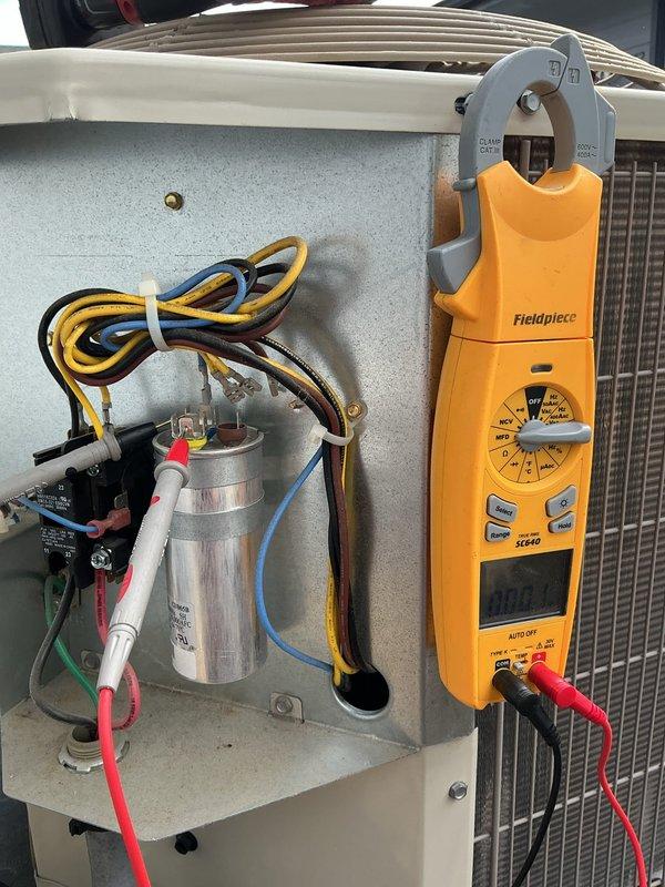 Responded to no cooling complaint on outdoor condensing unit U10. Upon arrival, system was running but not producing cool air. Performed electrical diagnostics using clamp meter to test amperage and voltage at capacitor and contactor. Identified failed capacitor preventing compressor from operating at proper capacity. Replaced defective dual-run capacitor, verified proper electrical connections, and tested contactor operation. Confirmed compressor amperage within manufacturer specifications and system returned to normal cooling operation.