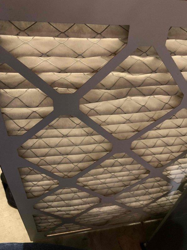 Completed comprehensive cooling system tune-up on residential HVAC unit located at side of house (under 10 years old). Performed full system inspection including examination of control board, electrical connections, and capacitors. Inspected and documented condition of air filter, which showed moderate dust accumulation and discoloration requiring attention. All electrical components, wiring connections, and control board functioning properly with no issues identified during service.