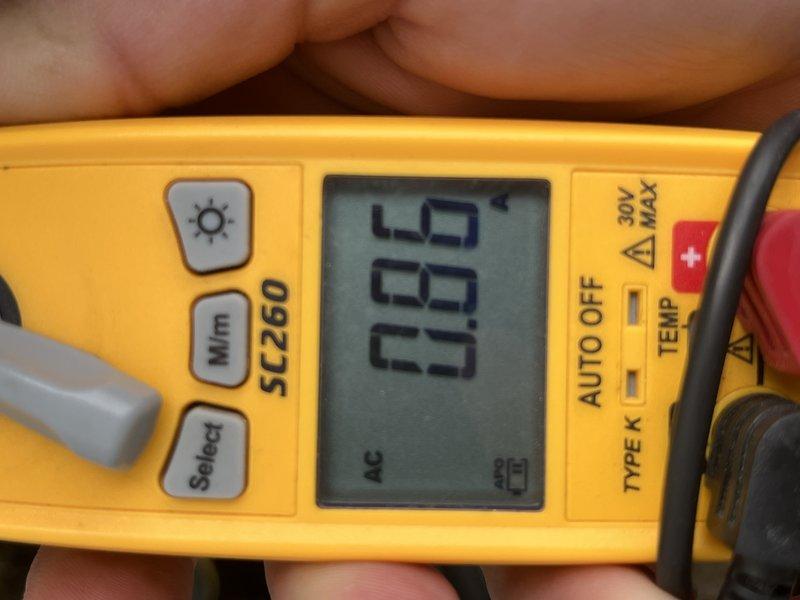 Completed comprehensive cooling tune-up on single outdoor ground-mounted AC unit of unknown age. Performed standard diagnostic testing using digital multimeter, recording temperature readings of 67.7°F and electrical measurements of 0.03 AC volts to verify proper system operation and electrical integrity.