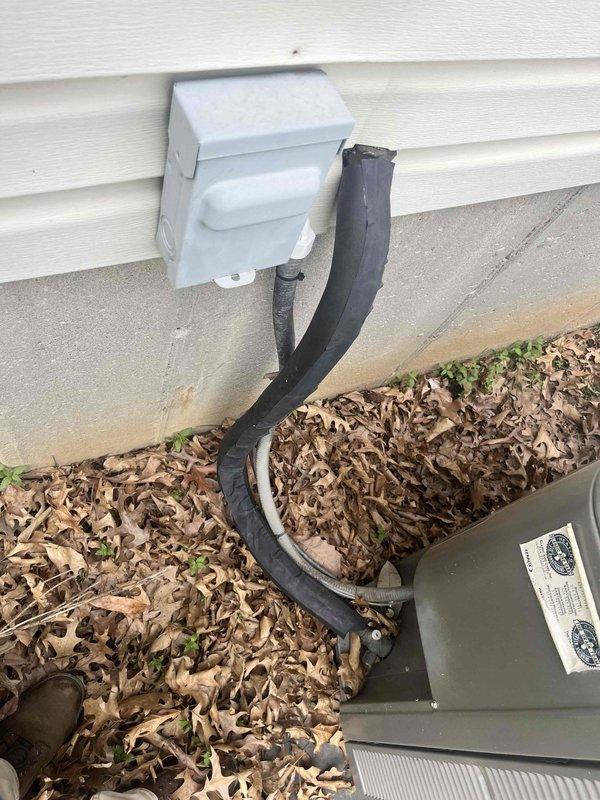 Responded to service call for 11-year-old outdoor A/C unit with damaged foam insulation on refrigerant line set. Upon inspection, found that the foam insulation covering the suction line had split open and deteriorated due to winter weather exposure. Replaced damaged foam insulation on exposed refrigerant piping to restore proper insulation and prevent efficiency loss and condensation issues.